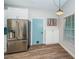 Modern kitchen with white cabinets, blue tile backsplash, and stainless steel appliances at 812 Franklin Cir, Palm Harbor, FL 34683