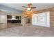 Living area with brick fireplace, french doors and ceiling fan at 12593 80Th Ave, Seminole, FL 33776