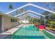 Inviting screened pool with a red tile water feature at 12593 80Th Ave, Seminole, FL 33776