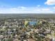 Aerial view of a residential neighborhood with houses, roads, and a lake at 11117 Bloomington Dr, Tampa, FL 33635