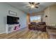 Living room with brown sectional, wood floors, and access to a patio at 11341 Flora Springs Dr, Riverview, FL 33579