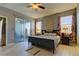 Large main bedroom with wood-look floors and sliding doors to balcony at 11341 Flora Springs Dr, Riverview, FL 33579