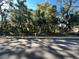 Street view showcasing a property with a fenced yard and many trees at 12308 N 52Nd St, Temple Terrace, FL 33617