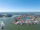 Aerial view of waterfront home with private dock and pool at 15 Marina Ter, Treasure Island, FL 33706