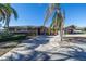 Ranch style home with palm trees and driveway at 15 Marina Ter, Treasure Island, FL 33706