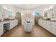 Elegant bathroom with double vanities, soaking tub, and large mirrors at 15435 27Th E Ct, Parrish, FL 34219