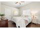 Cozy bedroom with hardwood floors, neutral decor, and a ceiling fan at 15435 27Th E Ct, Parrish, FL 34219