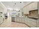 Open kitchen with breakfast bar, island and view into Gathering room at 15435 27Th E Ct, Parrish, FL 34219