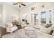 Bright living room features comfortable seating, large windows, and access to a relaxing patio at 15435 27Th E Ct, Parrish, FL 34219