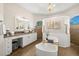 Luxurious bathroom with soaking tub, walk-in shower, and modern vanity at 15435 27Th E Ct, Parrish, FL 34219