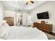 Main bedroom with ensuite bathroom, walk-in closet and large TV at 15435 27Th E Ct, Parrish, FL 34219