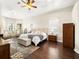 Large main bedroom with ample space, hardwood floors and a ceiling fan at 15435 27Th E Ct, Parrish, FL 34219