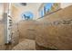 Large walk-in shower with multiple shower heads and a built-in seat at 15435 27Th E Ct, Parrish, FL 34219