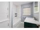 Updated bathroom features marble vanity, hexagon tile, and subway tile shower at 2621 13Th N St, St Petersburg, FL 33704