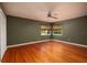 Large bedroom with hardwood floors, ceiling fan, and green walls at 2621 13Th N St, St Petersburg, FL 33704