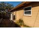 Tan house exterior with AC unit and small window at 2621 13Th N St, St Petersburg, FL 33704