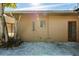 Tan house exterior with red door and small window at 2621 13Th N St, St Petersburg, FL 33704