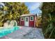 Red pool shed with windows and a door at 2621 13Th N St, St Petersburg, FL 33704