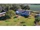 Rear view of house with large yard and outbuildings at 3111 Lewis Rd, Dover, FL 33527