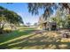 Large grassy backyard with a wooden shed at 3111 Lewis Rd, Dover, FL 33527