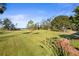 Expansive grassy backyard offering a tranquil lake view at 3111 Lewis Rd, Dover, FL 33527