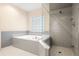 Bathroom featuring a large shower and a jetted tub at 3111 Lewis Rd, Dover, FL 33527
