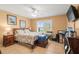 Bright bedroom with a queen bed, wood furniture, and large window at 3111 Lewis Rd, Dover, FL 33527