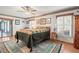 Bright bedroom with wood floors, featuring a view of the backyard at 3111 Lewis Rd, Dover, FL 33527