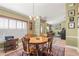Bright dining room with wooden table and views to living room at 3111 Lewis Rd, Dover, FL 33527