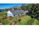 Ranch-style home with blue siding, red shutters, and a spacious lawn at 3111 Lewis Rd, Dover, FL 33527