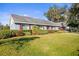 Ranch style home with blue exterior and red accents at 3111 Lewis Rd, Dover, FL 33527