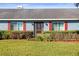 Blue home with red shutters, screen door, and manicured hedges at 3111 Lewis Rd, Dover, FL 33527