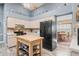 Open kitchen with island, stainless steel appliances and view into dining room at 3111 Lewis Rd, Dover, FL 33527