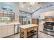 Spacious kitchen with an island, stainless steel appliances, and wood cabinets at 3111 Lewis Rd, Dover, FL 33527