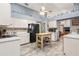 Open kitchen with island, stainless steel appliances and view into dining room at 3111 Lewis Rd, Dover, FL 33527