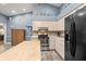 Kitchen features stainless steel appliances and an island with butcher block top at 3111 Lewis Rd, Dover, FL 33527