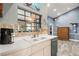 Kitchen with double sink, stainless steel dishwasher, and wood cabinets at 3111 Lewis Rd, Dover, FL 33527