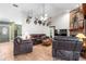 Spacious living room with leather furniture and a brick fireplace at 3111 Lewis Rd, Dover, FL 33527