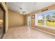 Bright sunroom with tile floor, brick walls, and access to backyard at 3111 Lewis Rd, Dover, FL 33527