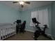 Bedroom with crib, Peloton bike, and home office setup at 3159 138Th Pl, Largo, FL 33771