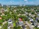 Expansive aerial view of the charming home and its lush surroundings, near the stunning city skyline and sparkling bay waters at 3509 W Leona St, Tampa, FL 33629