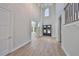 Two-story foyer with natural lighting, double doors, and wood-look floors at 3509 W Leona St, Tampa, FL 33629