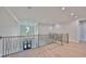 Stunning second floor hallway with metal staircase overlooking front door with chandelier at 3509 W Leona St, Tampa, FL 33629