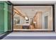 A large kitchen with an island is seen through a pass through window to the living room at 3509 W Leona St, Tampa, FL 33629