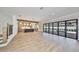 Open concept living room with hardwood floors and sliding glass doors to backyard at 3509 W Leona St, Tampa, FL 33629