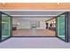 The open living space is enhanced by folding glass doors, creating a seamless indoor-outdoor experience at 3509 W Leona St, Tampa, FL 33629
