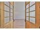 Home office showcasing light wood flooring and wood framed glass doors at 3509 W Leona St, Tampa, FL 33629