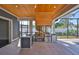 Modern outdoor kitchen featuring stainless steel appliances, a wooden ceiling, and a grill to enjoy alfresco cooking at 3509 W Leona St, Tampa, FL 33629