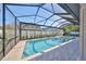 Bright and airy screened-in pool area featuring a pool and spa, perfect for year-round enjoyment at 3509 W Leona St, Tampa, FL 33629