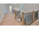 Second floor staircase with light hardwood floors and iron balusters at 3509 W Leona St, Tampa, FL 33629